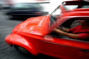 bigstock-Man-driving-fast-52416469