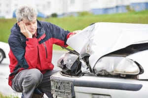 Adult upset driver man inspecting automobile body after crash ca